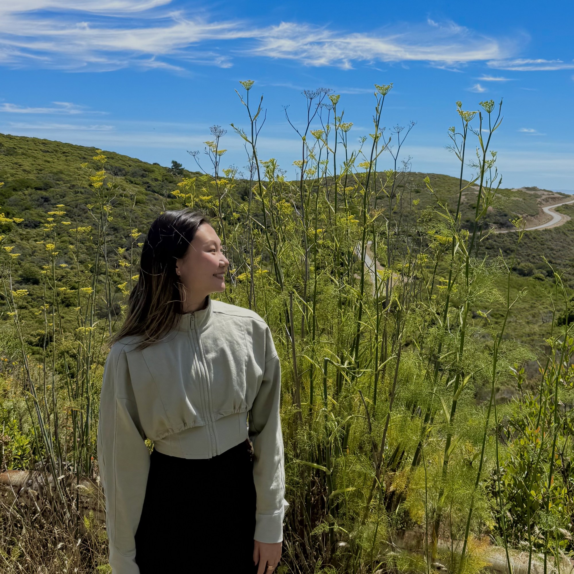 Cassie standing outdoors on a nature trail