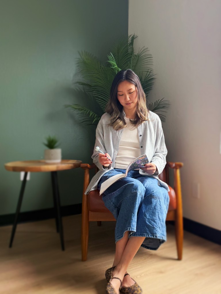 Cassie Feng in a portrait taking notes